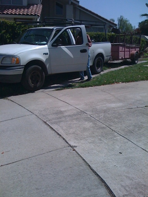 CEO, S. Wesonga just arrived at job site, getting out of his Ford f150 with a landscaping trailer behind. Company CEO. arriving.